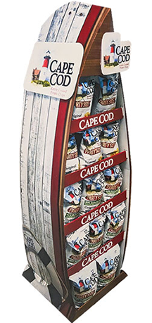 Retail display featuring Cape Cod snacks in a lighthouse-shaped stand, designed to attract customer attention.