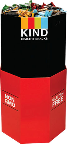 KIND snack display featuring a variety of bars, labeled gluten-free and non-GMO, promoting healthy snacking options.