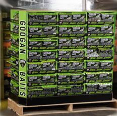 Display of Googan Baits products stacked on a pallet, showcasing various fishing bait options in vibrant packaging.