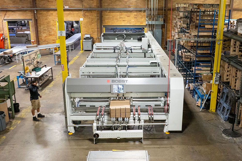 Automated packaging machinery in a warehouse, showcasing advanced technology for efficient production processes.