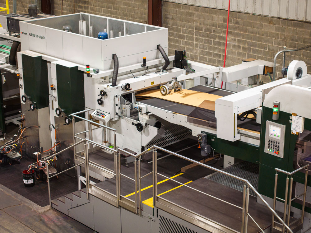 Advanced printing machinery in a manufacturing facility, showcasing high-tech equipment for production processes.