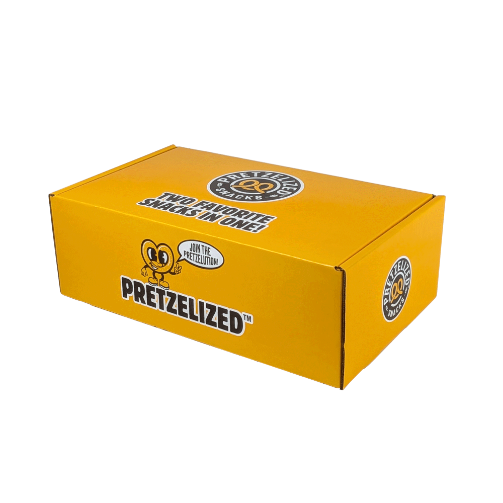 Bright yellow snack box labeled "Pretzelized" featuring the tagline "Two favorite snacks in one!" for e-commerce packaging.
